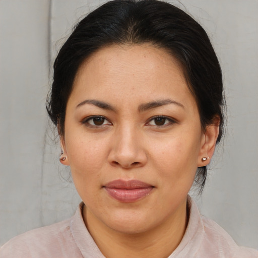 Joyful asian adult female with medium  brown hair and brown eyes