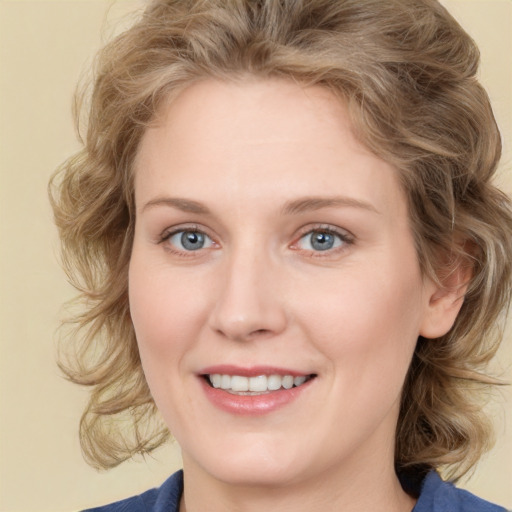 Joyful white young-adult female with medium  brown hair and blue eyes