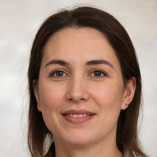 Joyful white adult female with medium  brown hair and brown eyes