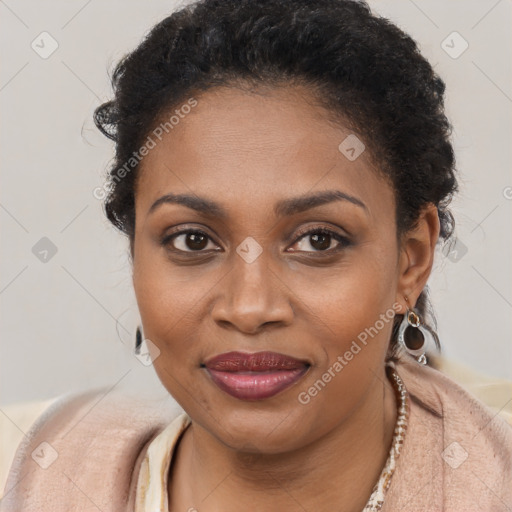 Joyful black young-adult female with long  brown hair and brown eyes