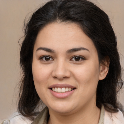 Joyful latino young-adult female with medium  brown hair and brown eyes