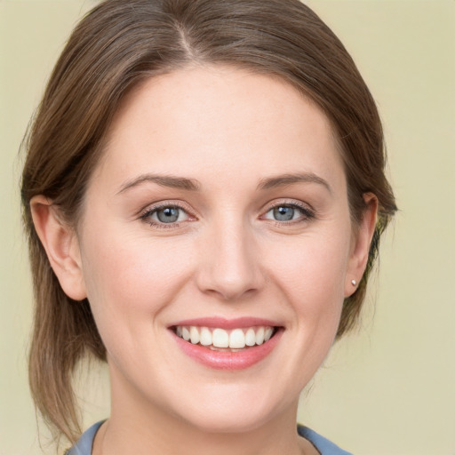 Joyful white young-adult female with medium  brown hair and blue eyes