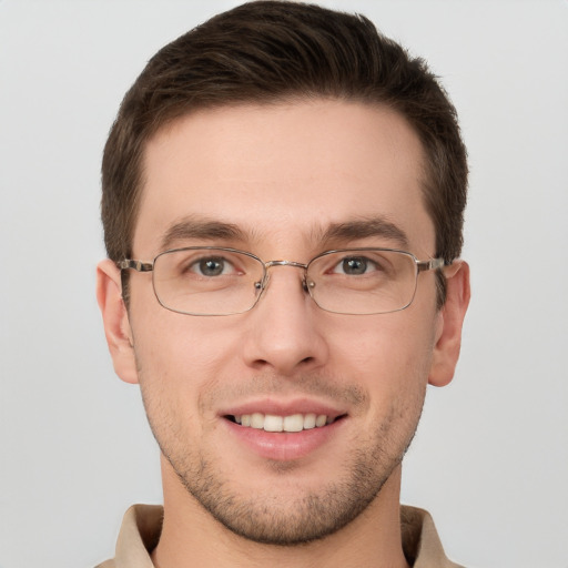 Joyful white young-adult male with short  brown hair and grey eyes