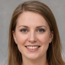 Joyful white young-adult female with long  brown hair and grey eyes