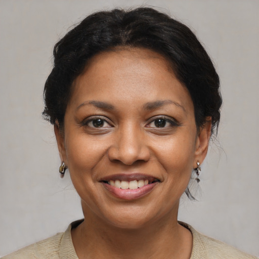 Joyful latino adult female with short  brown hair and brown eyes