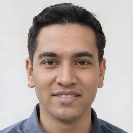 Joyful white young-adult male with short  black hair and brown eyes