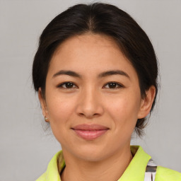 Joyful asian young-adult female with medium  brown hair and brown eyes