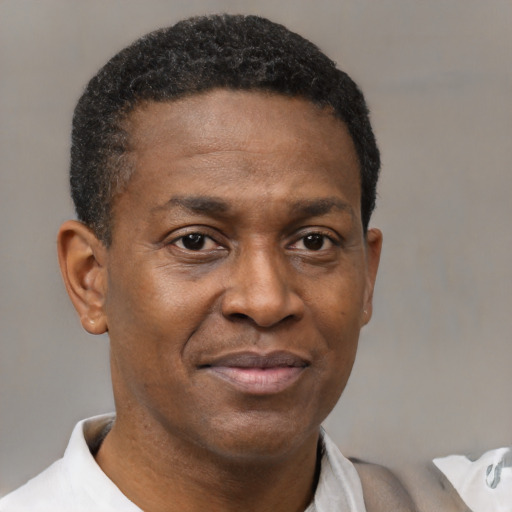 Joyful latino adult male with short  black hair and brown eyes