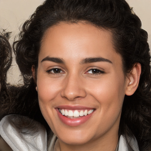 Joyful white young-adult female with long  brown hair and brown eyes