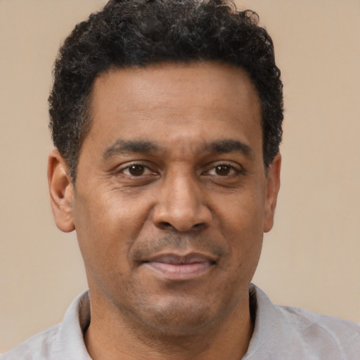 Joyful latino adult male with short  brown hair and brown eyes
