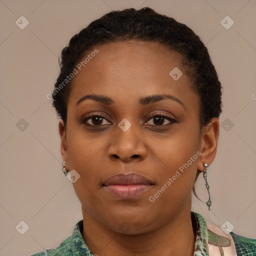 Joyful black young-adult female with short  black hair and brown eyes