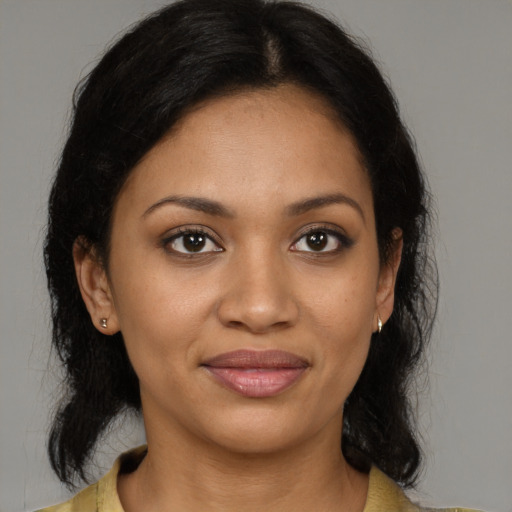 Joyful black young-adult female with medium  brown hair and brown eyes