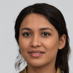 Joyful latino young-adult female with medium  brown hair and brown eyes