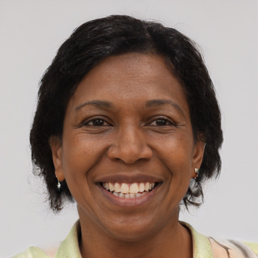 Joyful black adult female with short  brown hair and brown eyes