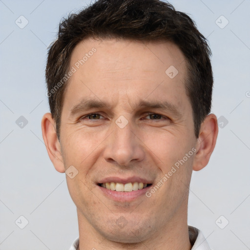 Joyful white adult male with short  brown hair and brown eyes