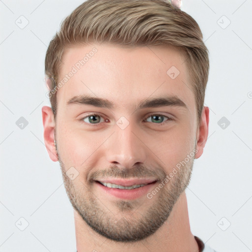 Joyful white young-adult male with short  brown hair and grey eyes