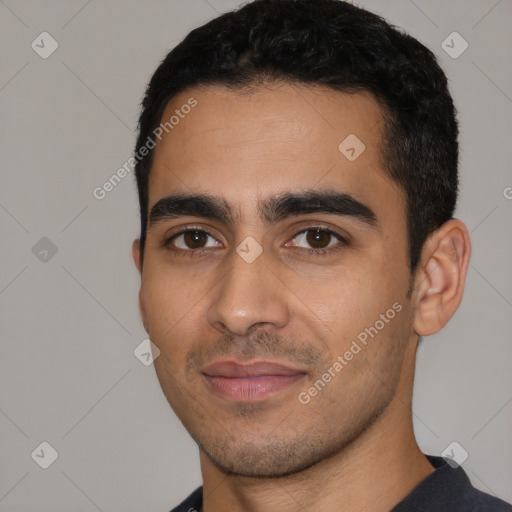 Joyful latino young-adult male with short  black hair and brown eyes