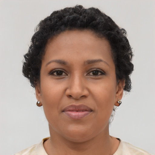 Joyful black young-adult female with short  brown hair and brown eyes