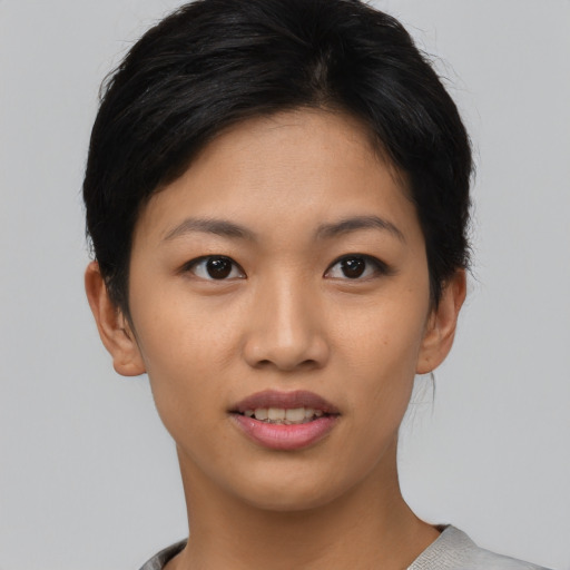 Joyful asian young-adult female with short  brown hair and brown eyes