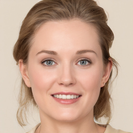 Joyful white young-adult female with medium  brown hair and blue eyes