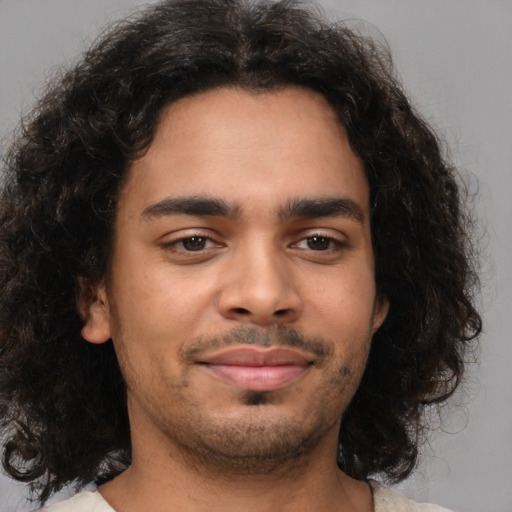 Joyful latino young-adult male with medium  brown hair and brown eyes