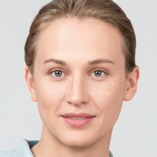 Joyful white young-adult female with short  brown hair and grey eyes