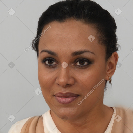 Joyful black young-adult female with short  black hair and brown eyes