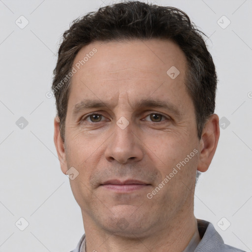 Joyful white adult male with short  brown hair and brown eyes