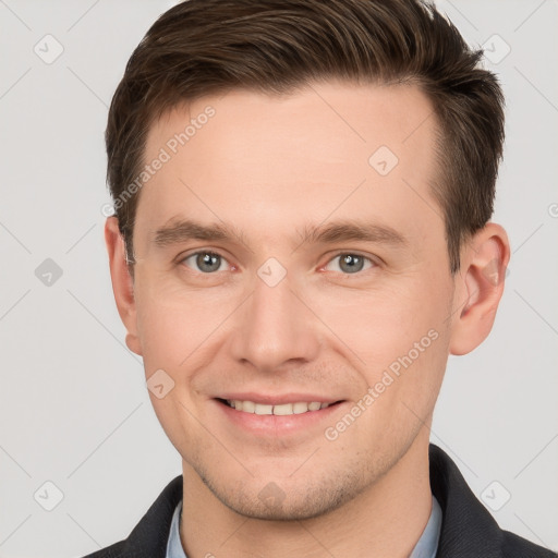 Joyful white young-adult male with short  brown hair and grey eyes