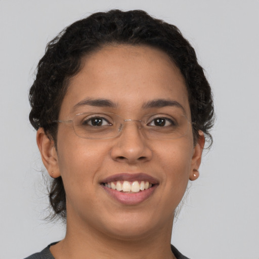 Joyful latino young-adult female with short  brown hair and brown eyes