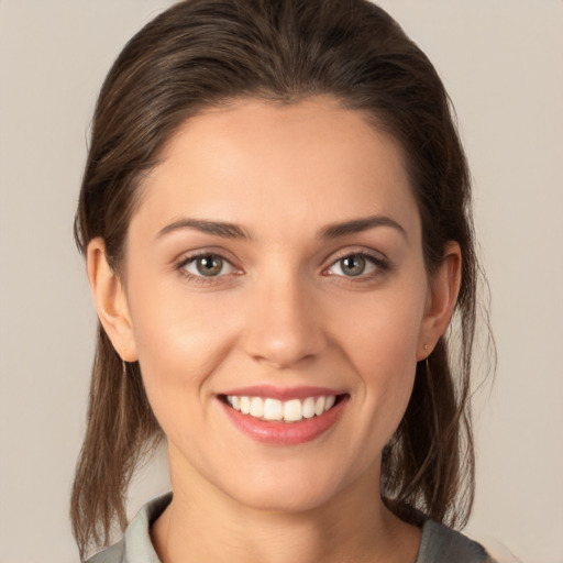 Joyful white young-adult female with medium  brown hair and brown eyes