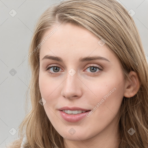 Joyful white young-adult female with long  brown hair and blue eyes