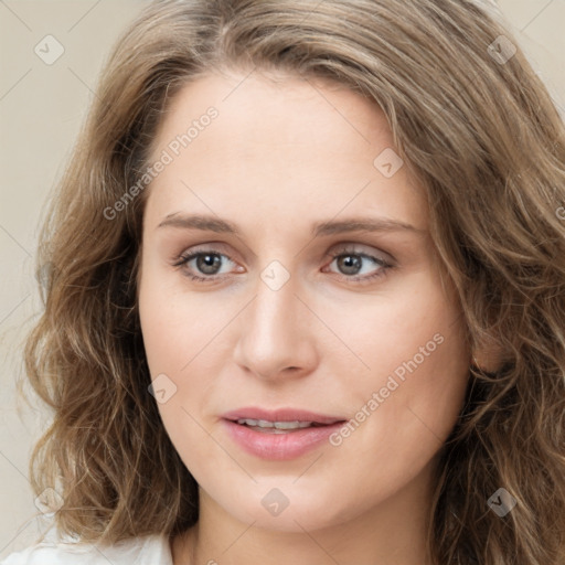 Joyful white young-adult female with long  brown hair and green eyes