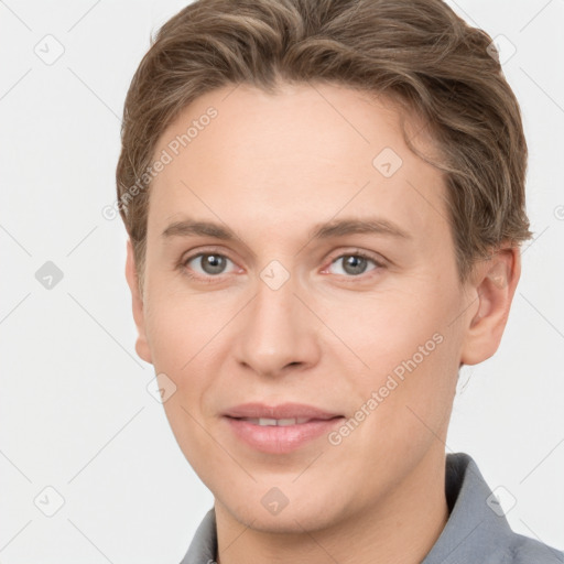 Joyful white young-adult female with short  brown hair and grey eyes