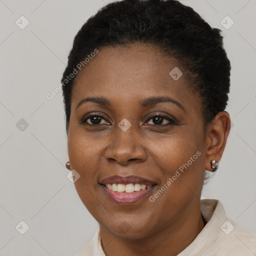 Joyful black young-adult female with short  brown hair and brown eyes