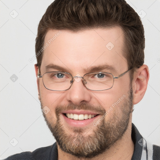 Joyful white adult male with short  brown hair and grey eyes