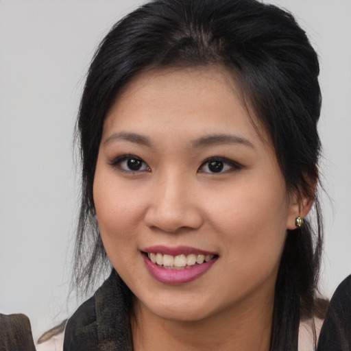 Joyful asian young-adult female with medium  brown hair and brown eyes