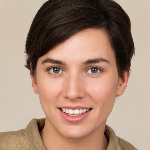 Joyful white young-adult female with short  brown hair and brown eyes