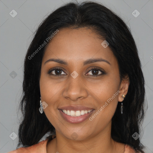 Joyful black young-adult female with long  brown hair and brown eyes