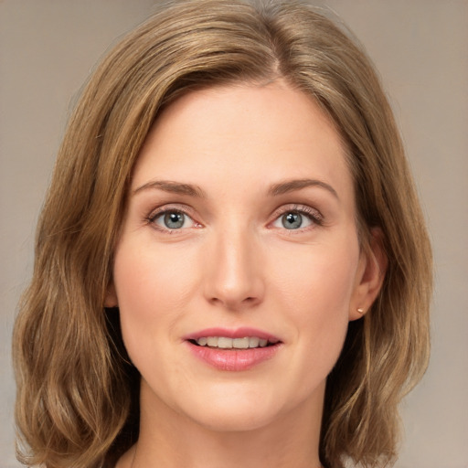 Joyful white young-adult female with medium  brown hair and green eyes