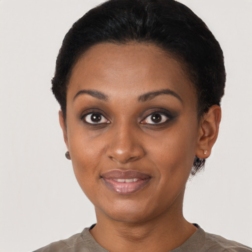 Joyful latino young-adult female with short  black hair and brown eyes
