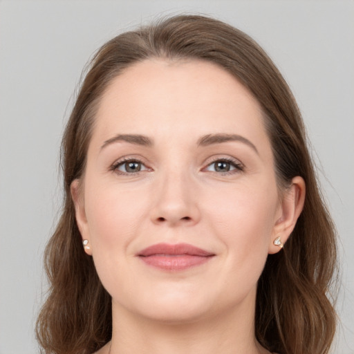 Joyful white young-adult female with medium  brown hair and grey eyes