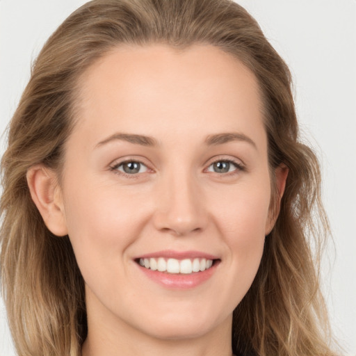 Joyful white young-adult female with long  brown hair and grey eyes