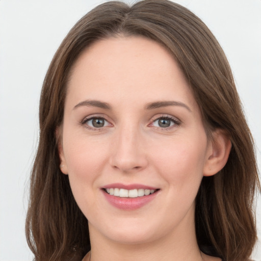 Joyful white young-adult female with long  brown hair and grey eyes