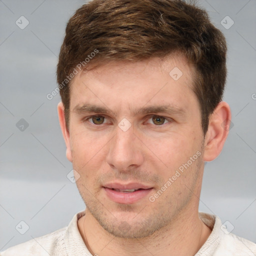 Joyful white young-adult male with short  brown hair and grey eyes