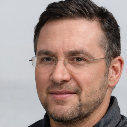 Joyful white adult male with short  brown hair and brown eyes