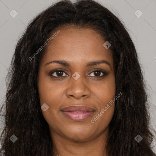 Joyful black young-adult female with long  brown hair and brown eyes