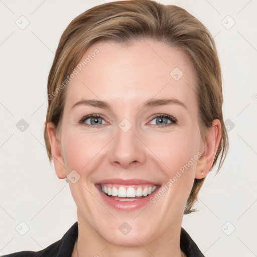 Joyful white young-adult female with medium  brown hair and grey eyes