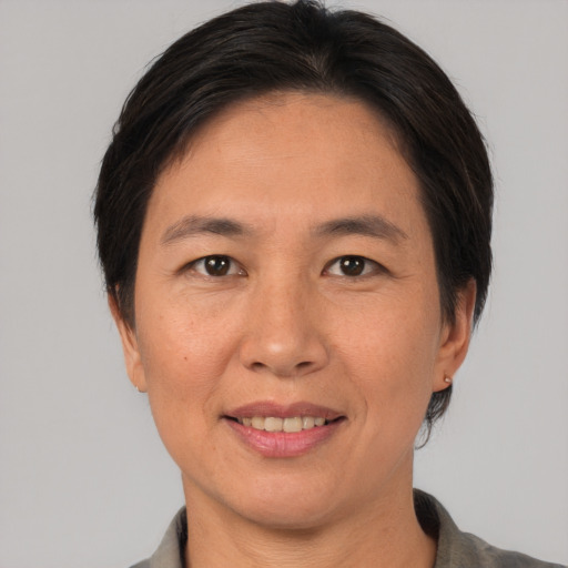 Joyful asian adult female with short  brown hair and brown eyes