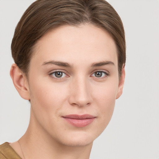 Joyful white young-adult female with short  brown hair and grey eyes